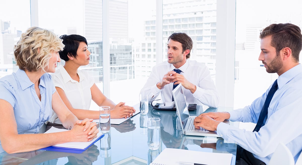 executives-sitting-around-conference-table